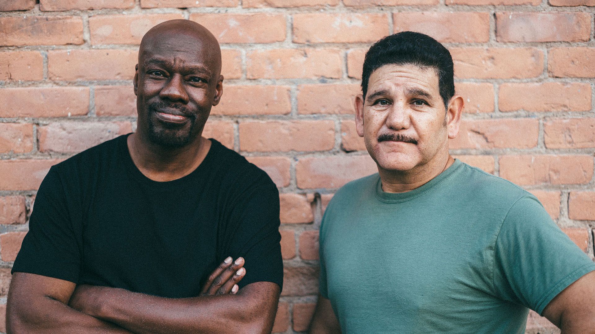 Two men, both sporting excellent moustaches, looking to camera in an ambiguous but nonetheless determined kind of way.